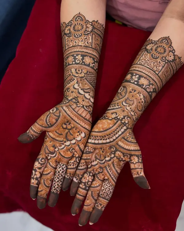 An inspiration photo for engagement mehendi, featuring beautiful, flowing patterns that extend up the arm.