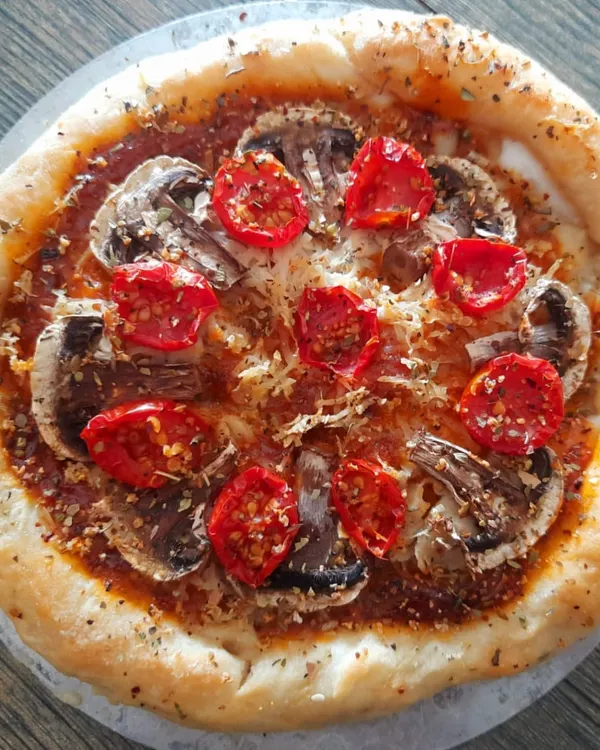 My gluten-free stuffed crust pizza with mushrooms and cherry tomatoes, a perfect example of healthy, vegan indulgence.