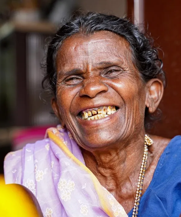 The incredible, heartwarming smile of an 'aaji' I met. This close-up shot in vibrant color captures the sheer happiness and life in her eyes, a moment of pure, unadulterated joy.
