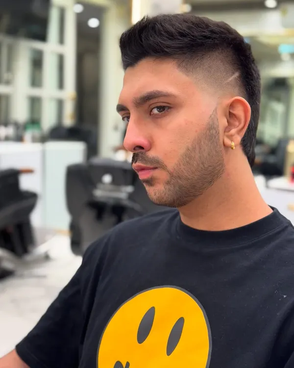 A different angle on this perfectly executed modern mullet. The fade is seamless, and the lines are razor-sharp, showing the precision I bring to every cut.