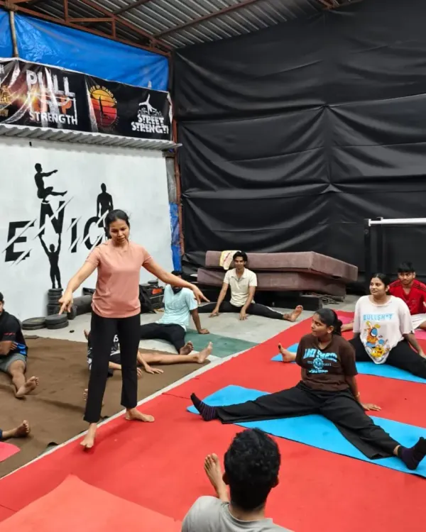 Our coach guides the class through a wide-legged seated forward bend (Upavistha Konasana), a great stretch for the inner thighs and hamstrings. We focus on proper form to ensure everyone gets the maximum benefit.