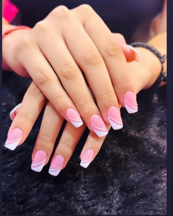 A perfect example of a modern classic. This design features a clean pink base with a sharp, angular white French tip for a contemporary look.