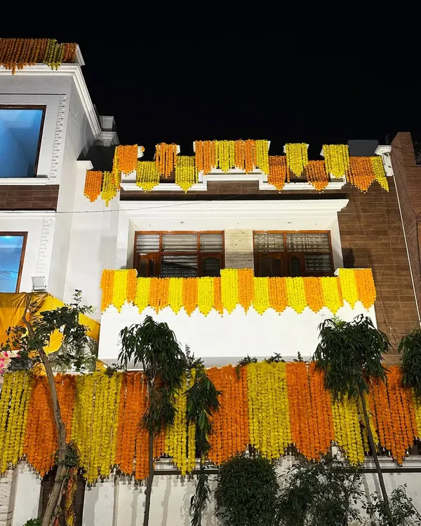 We gave this house a classic 'shaadi wala ghar' look with dense curtains of yellow and orange marigold garlands covering the entire facade.