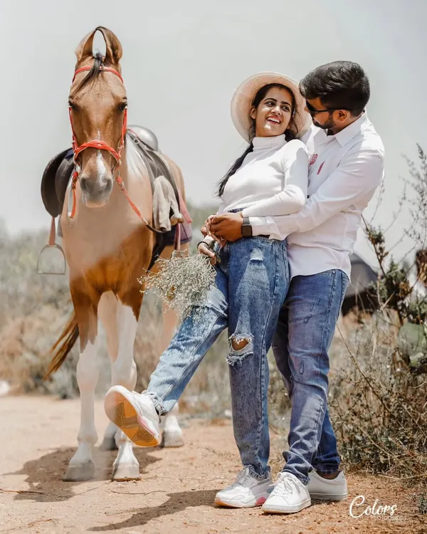 A fun and rustic shot with a horse, where the couple's casual denim outfits create a relaxed and playful vibe.