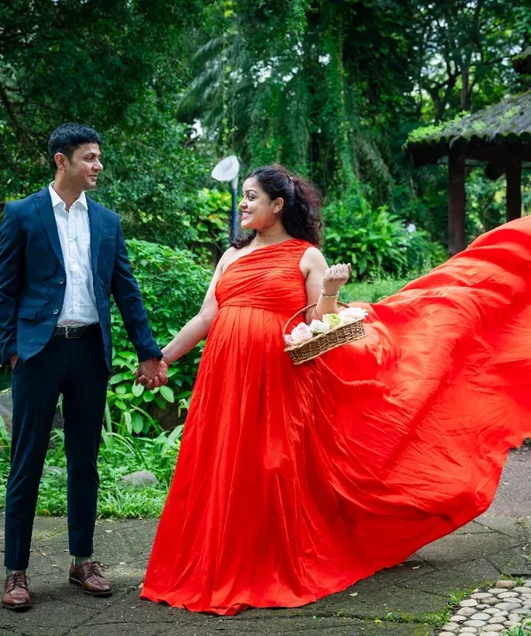 This is the kind of magic I love to create during an outdoor maternity session. The vibrant red gown flowing in the breeze, set against the lush greenery of a Mumbai park, perfectly captures the power and beauty of motherhood.