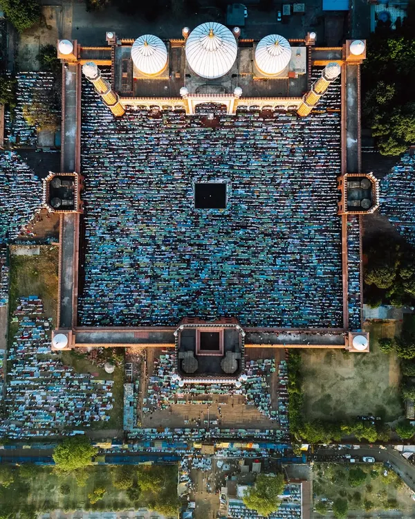 This top-down aerial view of Jama Masjid during Eid prayers captures the incredible density and beautiful, chaotic symmetry of thousands of worshippers. It’s a perspective that reveals a pattern of devotion invisible from the ground, showcasing my ability to capture the scale of massive events.