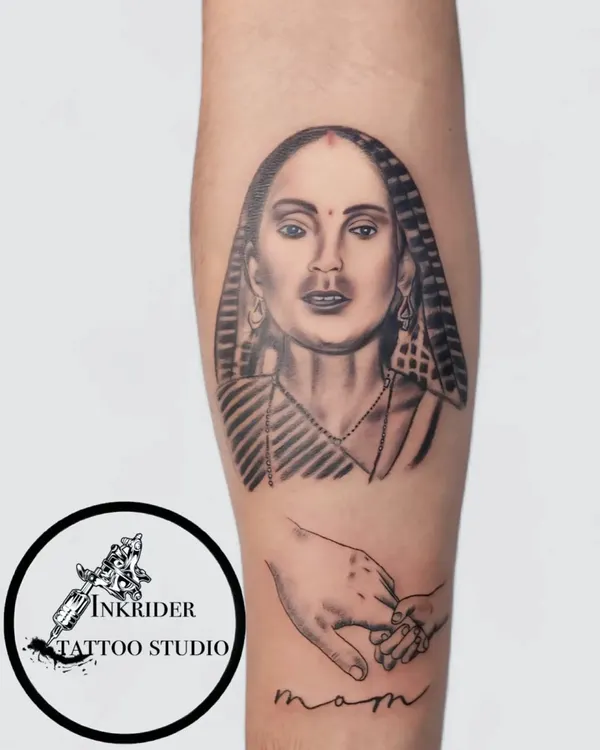 We transformed a faded, older portrait tattoo into this sharp and lifelike piece. This rework involved adding detailed shading, refining the facial features, and incorporating a new element of a mother holding a child's hand to create a more meaningful and visually stunning forearm tattoo.