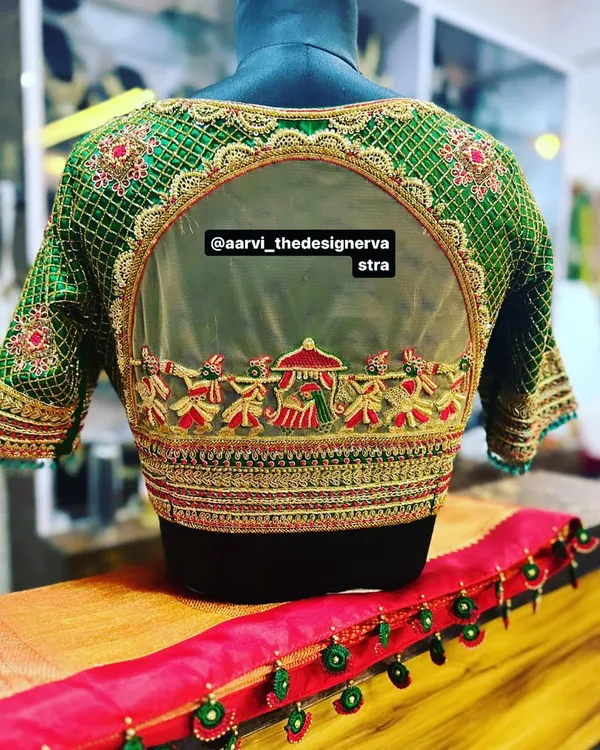 This is what I love to do, weave your stories into your outfit. This special blouse features a hand embroidered 'doli' scene, a beautiful and personal motif for our bride's big day, showcasing intricate zardozi and threadwork.
