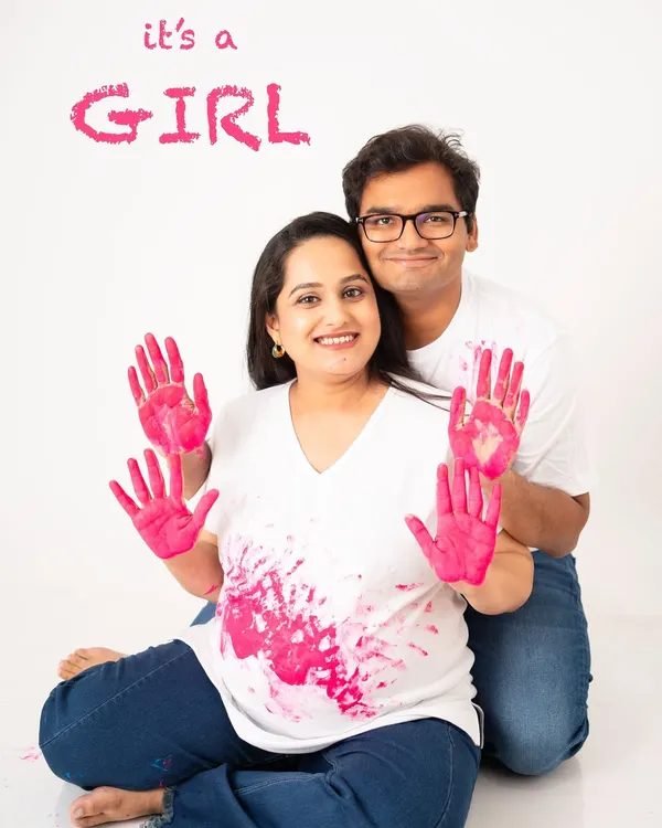 It's a girl! A gender reveal shoot is such a fun way to announce your big news. This couple's joy is palpable as they celebrate the upcoming arrival of their daughter with playful handprints.