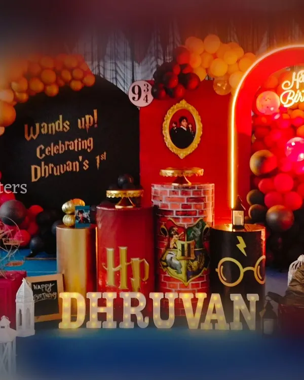 The complete Harry Potter themed birthday setup for Dhruvan's first birthday. Notice the custom pedestals, brick wall patterns, and the iconic font used for the name, creating a truly magical atmosphere for young wizards.