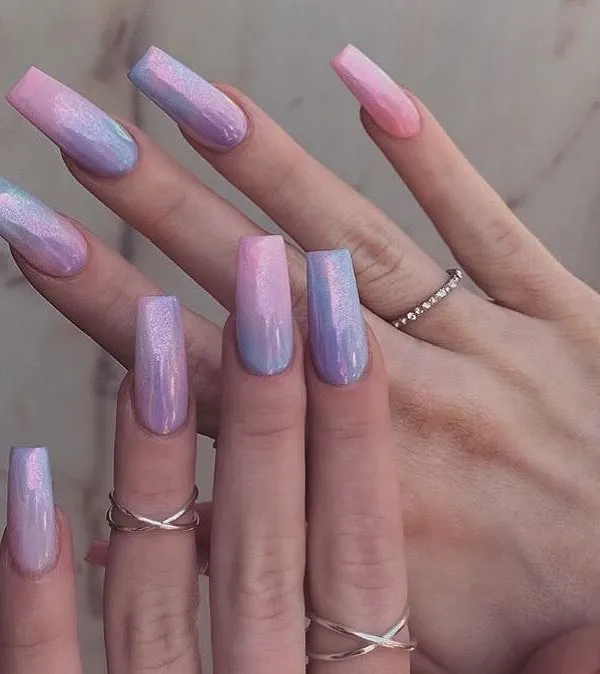 A trendy, long square set with a mesmerizing pastel pink and blue ombre. The entire set is finished with a reflective chrome powder that shifts in the light.