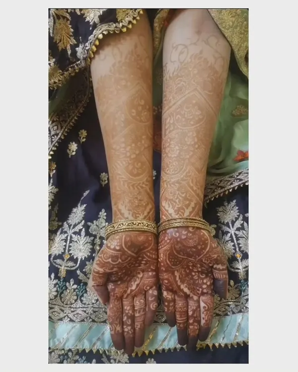 This is the final stain of a full-arm design after 48 hours. The color is a deep reddish-brown on the arms and even darker on the hands, showing the quality of the paste.