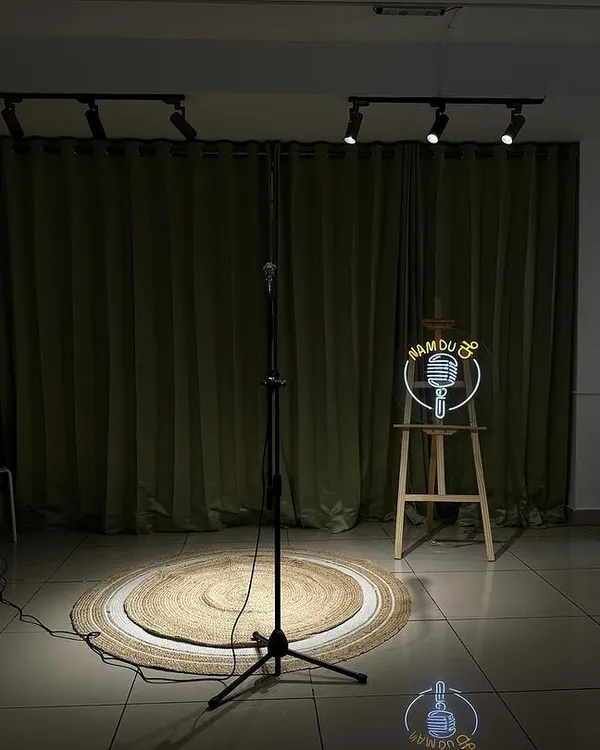 The stage is set. Our simple yet professional setup with a spotlight, mic, and backdrop is perfect for intimate gigs and stand-up shows.