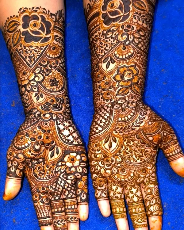 This is the kind of detail I love to create. A full coverage design for a bride, blending bold floral motifs with delicate, traditional Indian patterns to cover the hands completely.