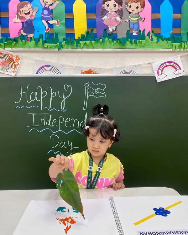 A young artist uses a leaf to print the colors of the Indian flag. This sensory art activity for Independence Day combines patriotism with a hands-on exploration of nature and textures.