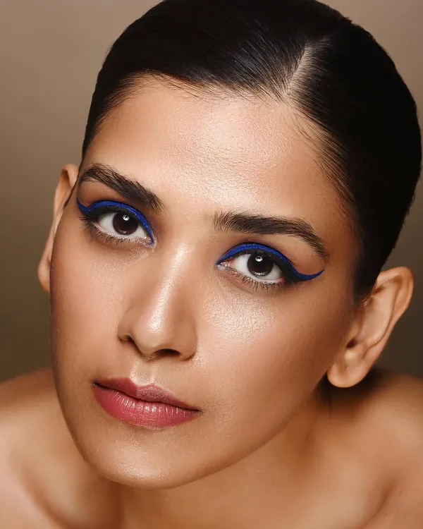 This clean beauty shot puts the focus squarely on the eyes. The sharp, electric blue eyeliner provides a pop of color against the model's natural skin tone, demonstrating my skill in capturing detailed makeup work for beauty campaigns or portfolios.