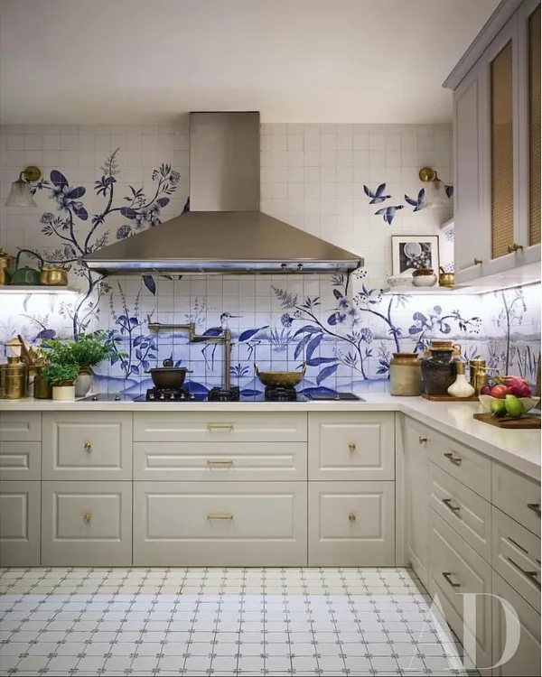 This kitchen is one of my favorite projects, a space that truly feels like a work of art. I collaborated with an artist to design these custom blue and white tiles, pairing them with classic cabinetry and modern appliances to create a kitchen that is both highly functional and uniquely beautiful.