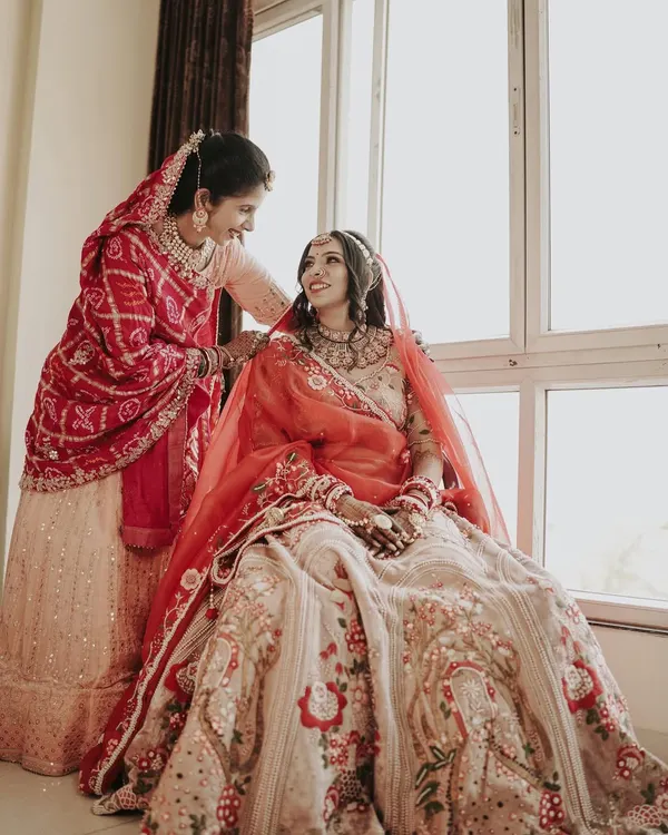 A heartwarming moment between the bride and her mother or sister. This candid shot captures the love and support of family on the wedding day.