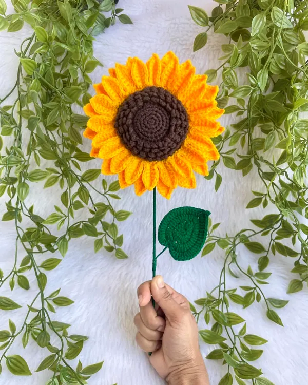 This life-sized crochet sunflower is almost 7 inches wide. Holding it up shows its impressive size and the detailed work that goes into each petal. It’s a statement piece all on its own.