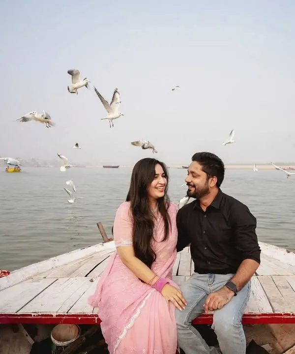An iconic shot from our Banaras pre-wedding series. The couple shares a laugh on a boat as seagulls fly around them, creating a magical and spontaneous moment.