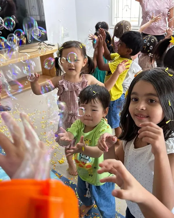I believe learning should be full of joy. Here, children are completely immersed in the simple delight of a bubble celebration, a perfect example of how I create a fun and energetic atmosphere for them to unwind and play after school.