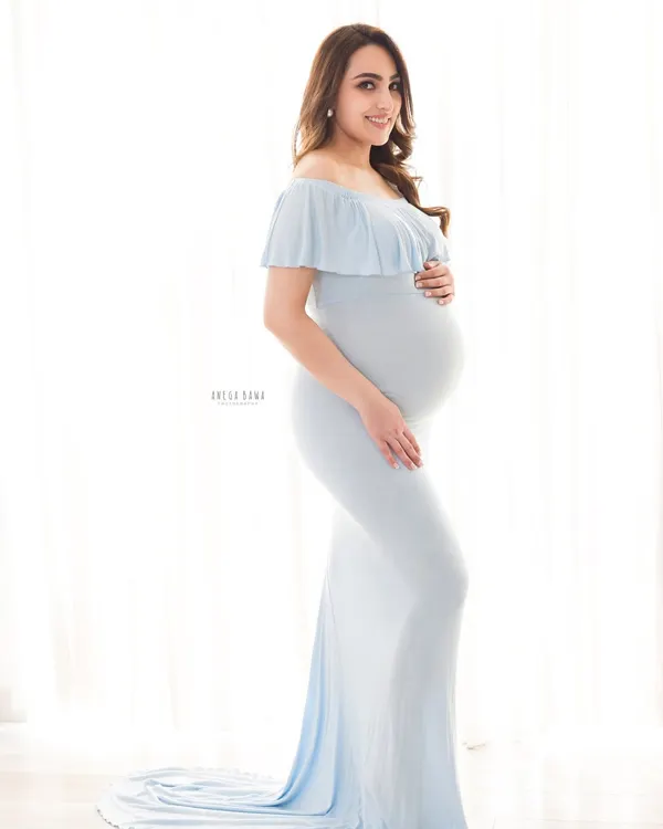 A classic solo maternity portrait using soft, beautiful window light. The light blue gown from my studio collection complements the bright and airy aesthetic perfectly.