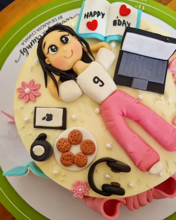 This cake is a perfect match for the birthday girl's hobbies. I created fondant versions of her laptop, headphones, cookies, and even a little book to capture her personality in edible form.