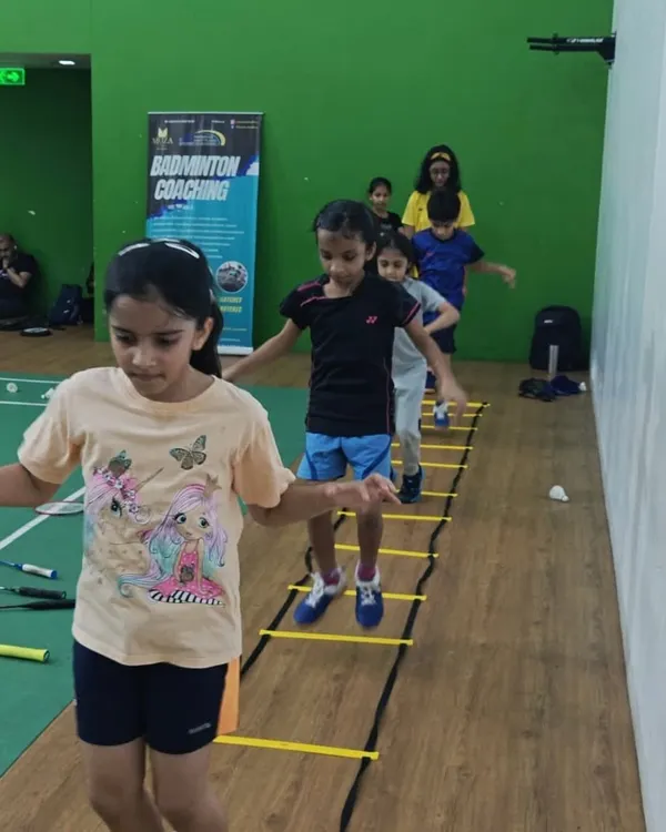 Quick feet are key in badminton. Our young players are seen here working on their agility and coordination with ladder drills, an essential exercise for improving on-court movement.