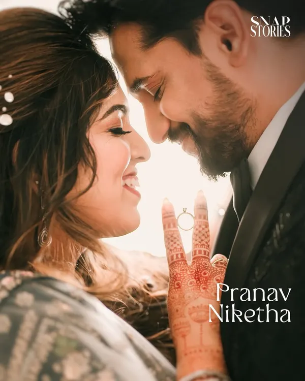 A beautiful backlit close-up focusing on the couple's connection and the engagement ring. This creative shot is a perfect way to highlight the details of your love story.