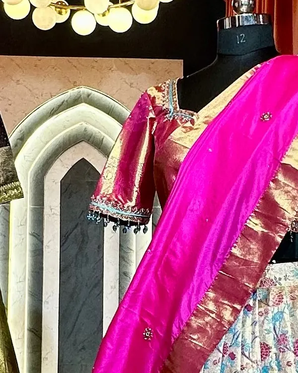 A glimpse of a custom saree lehenga on a mannequin in my studio. This one features a floral brocade skirt paired with a shimmering pink blouse and dupatta.