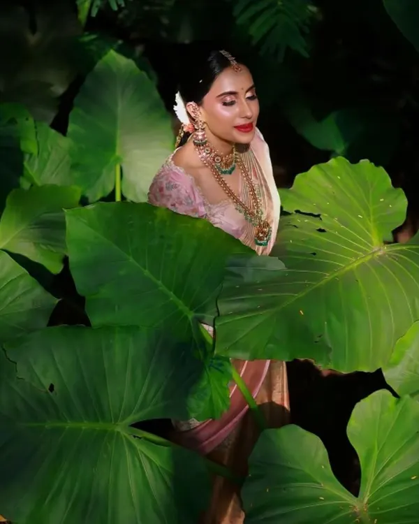 This is one of my favorite editorial-style bridal portraits. I created a soft, glowing makeup look with a defined eye and a classic lip that perfectly complements the traditional pink saree. The goal was a clean, radiant finish that looks stunning on camera, even when surrounded by lush, natural elements.