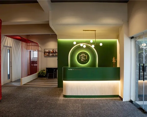 This is the main reception area of an office I designed, featuring our signature green branding. The wide view shows how the reception flows into different work zones, separated by glass and open partitions.