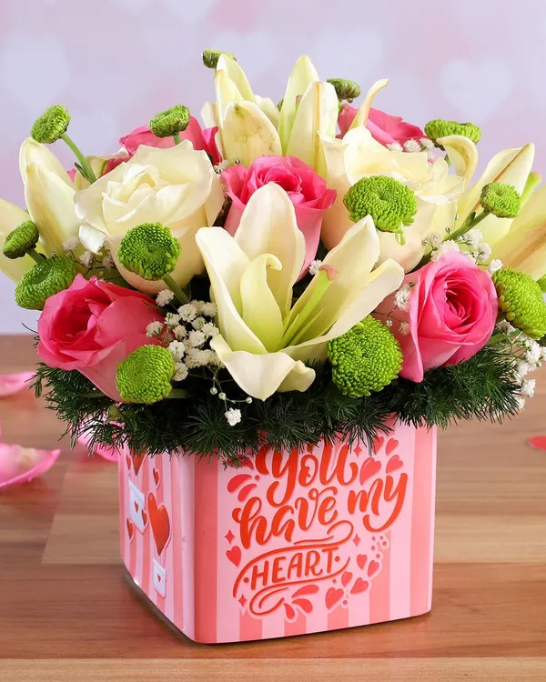 This modern box arrangement is one of my most popular romantic gifts. It features soft pink roses and elegant white lilies with fresh green accents, all beautifully presented in a "You have my heart" themed box, ready to make someone's day.