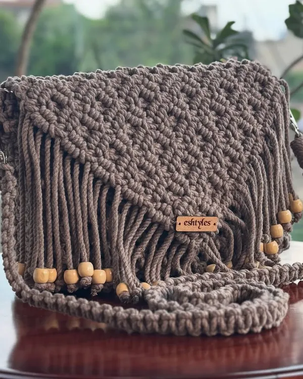 A closer look at the beautiful texture and fringe details on this brown sling bag. It's a versatile piece that goes with almost everything.