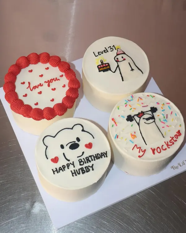 A fun and quirky set of four custom bento cakes for a birthday celebration. We included designs like a cute Winnie the Pooh, a weightlifting "rockstar" doodle, and a simple "love you" message to make it extra personal.