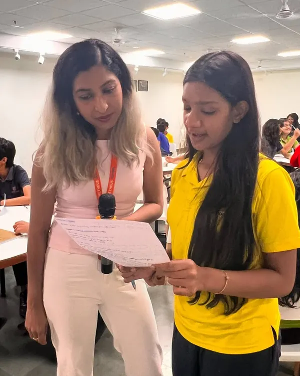 Our founder mentoring a student at Prometheus School during a poetry workshop. We provide one-on-one guidance to help young writers find their voice.