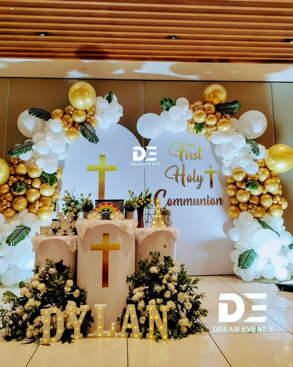 A beautiful and blessed setup for Dylan's First Holy Communion. We used elegant white and gold balloon arches, floral arrangements, and marquee lights to create a heavenly atmosphere.