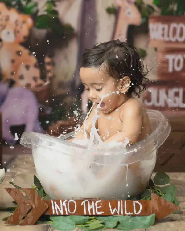 A huge splash in the tub. This action shot from our jungle-themed milk bath captures the pure, messy fun of the session.