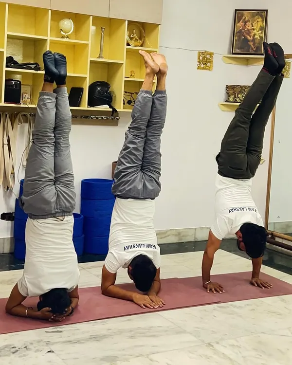 Here we see three powerful inversions side-by-side: Sirsasana (Headstand), Pincha Mayurasana (Forearm Stand), and Adho Mukha Vrksasana (Handstand). Each pose builds a unique combination of strength, balance, and mental focus.