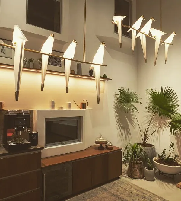 This is one of my favorite ways to blend art with function. For this office pantry, I used these beautiful bird-shaped decorative lights to create a striking visual centerpiece. This is balanced with integrated joinery lighting under the shelf, which provides perfect, shadow-free light for the task area below.