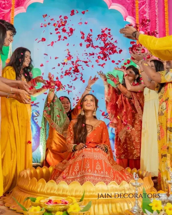 A moment of pure joy, showered in love and petals. I created this vibrant setting with a golden lotus seat for the bride, making her the radiant center of her Mehndi celebration.