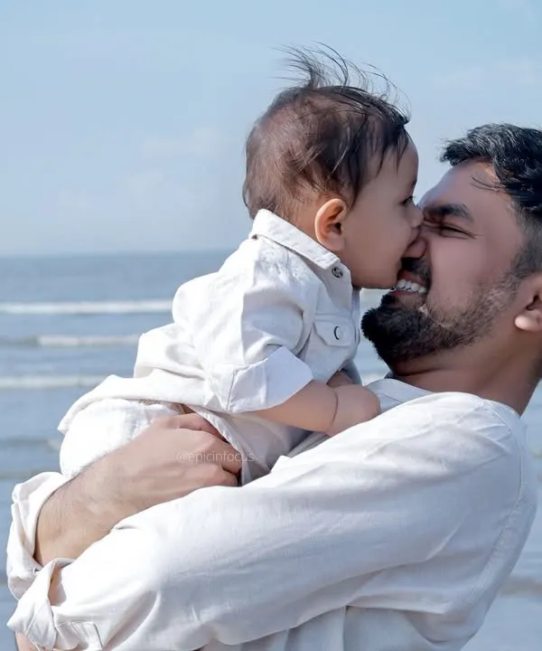A tender moment between father and son on the beach. The natural light and ocean backdrop create a timeless and heartfelt portrait.