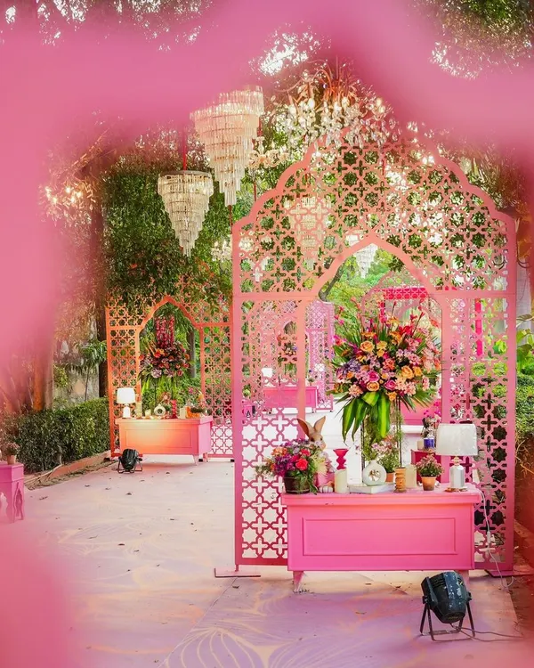 I transformed this outdoor space into a pink paradise for a Mehendi ceremony. Intricate jaali arches, chic chandeliers, and lush floral arrangements create a dreamy and whimsical atmosphere.