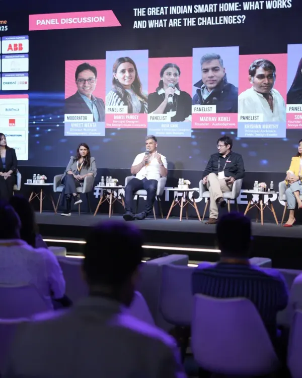 A wide shot of a panel discussion on "The Great Indian Smart Home," where experts debate the challenges and opportunities in the domestic market.