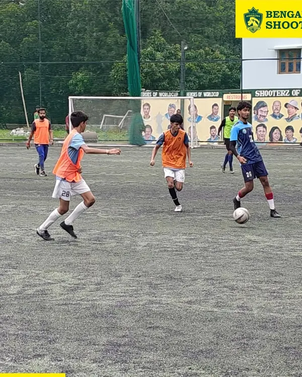 Our players in action during a competitive match, demonstrating ball control and spatial awareness. These game scenarios are crucial for developing tactical intelligence.