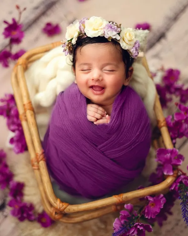 A sleepy smile is one of the most precious gifts from a newborn session. I love capturing these fleeting moments of pure contentment, wrapped cozily in a vibrant purple swaddle.