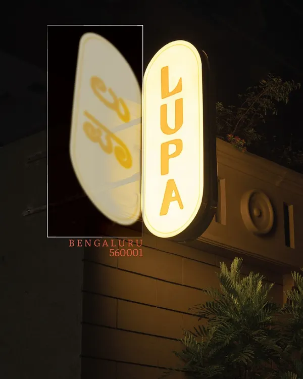 The Lupa sign at night, a beacon on MG Road. The reflection shows our name in Kannada, a nod to our home in Bengaluru.