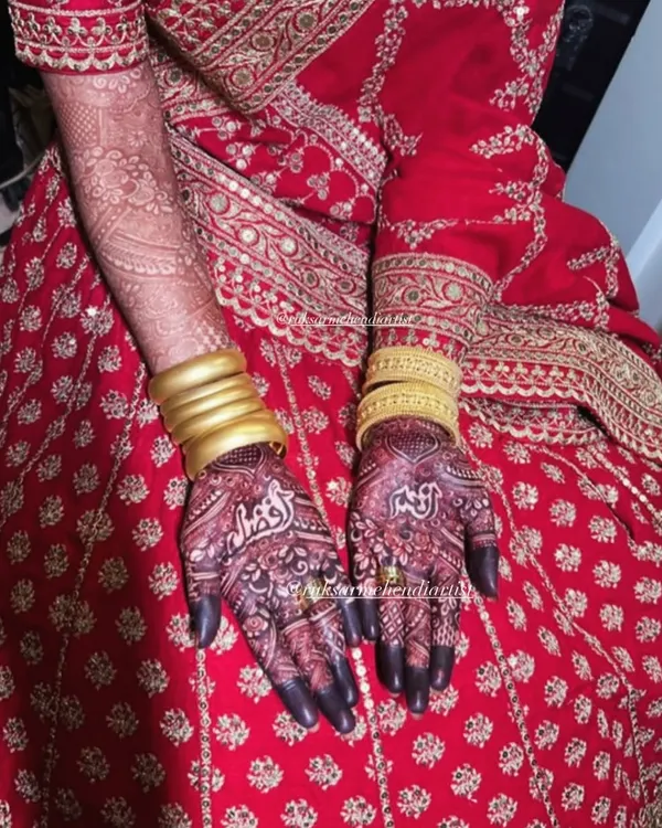 The perfect dark henna stain complementing a stunning red Sabyasachi bridal lehenga. This is the rich color I promise.
