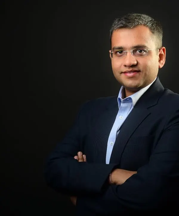 A classic corporate headshot against a solid dark background. This style provides a clean, timeless, and professional look, ideal for LinkedIn profiles, company directories, and speaker bios.