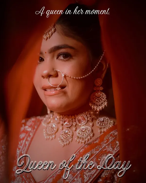 Every bride is the queen of her day. We captured this stunning close-up through her veil, focusing on her regal jewelry and confident expression, a perfect portrait of a bride ready to walk into her forever.
